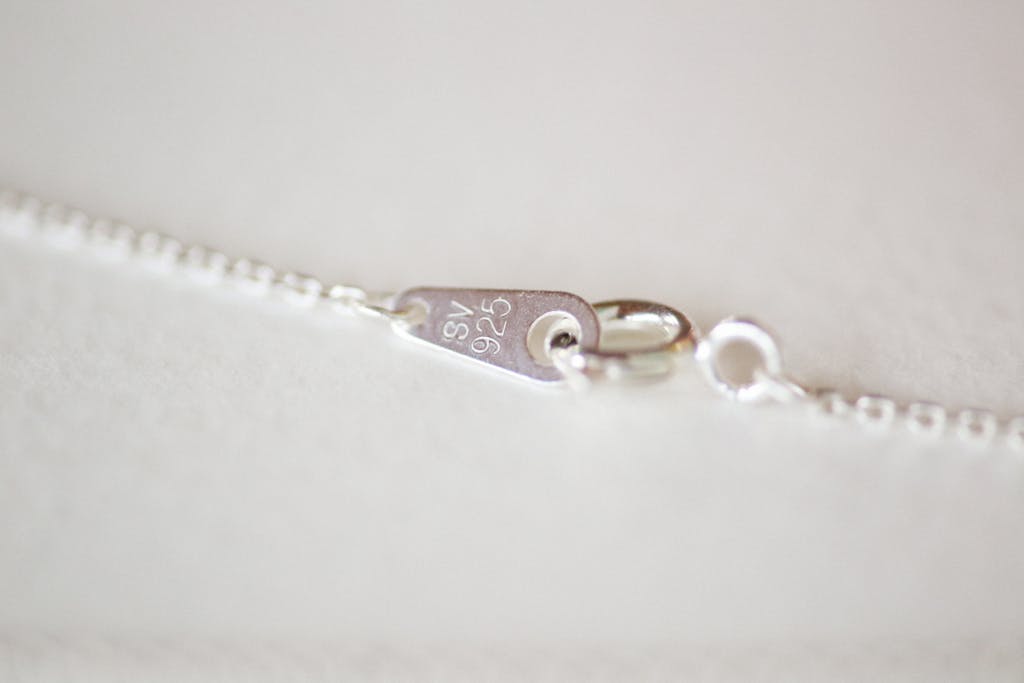 Detailed view of a sterling silver clasp on a necklace chain.